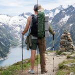 Rear view of a hiker split down the middle showing two setups: ultralight gear with a minimal backpack, shorts, and trail runners on the left; comfort gear with a large padded backpack, sleeping pad, long pants, and boots on the right.